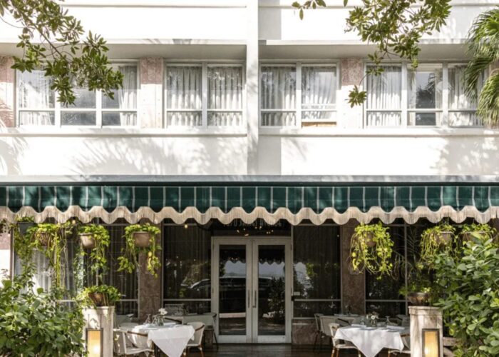 Art Deco facade with green awnings at Crest Hotel & Suites Miami Beach